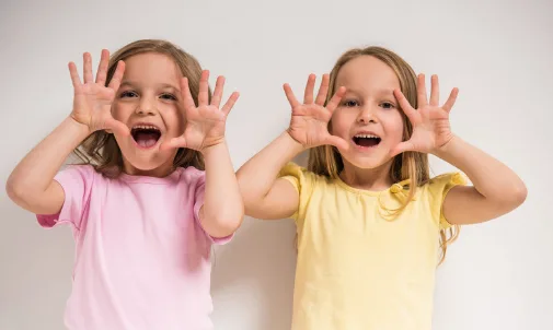 Two young girls playing and laughing together